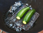 Zucchini on the grilling rack over the hot fire coals